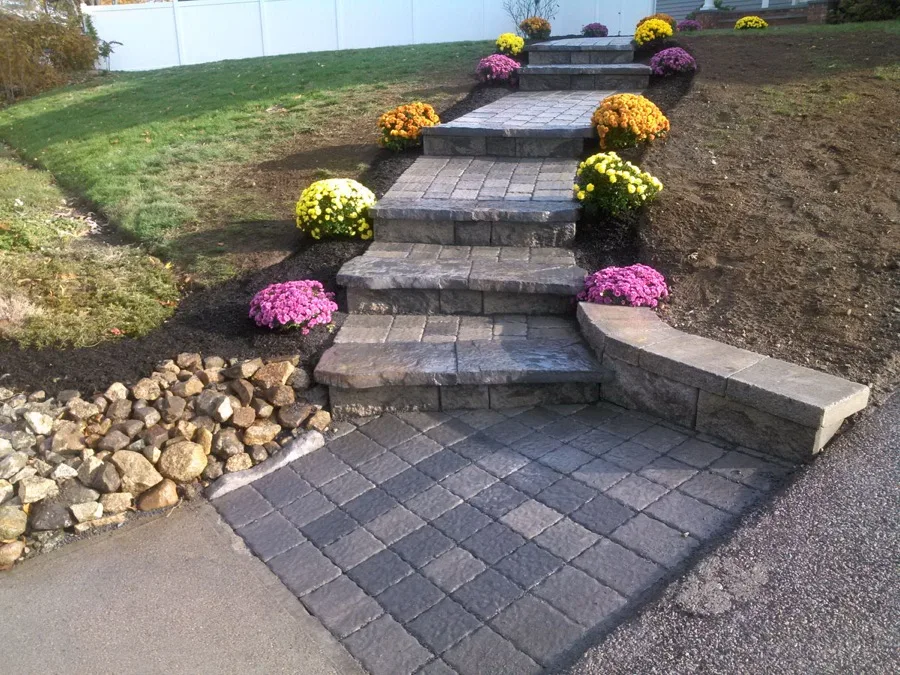 Stone paver walkway and steps installation with mum planters